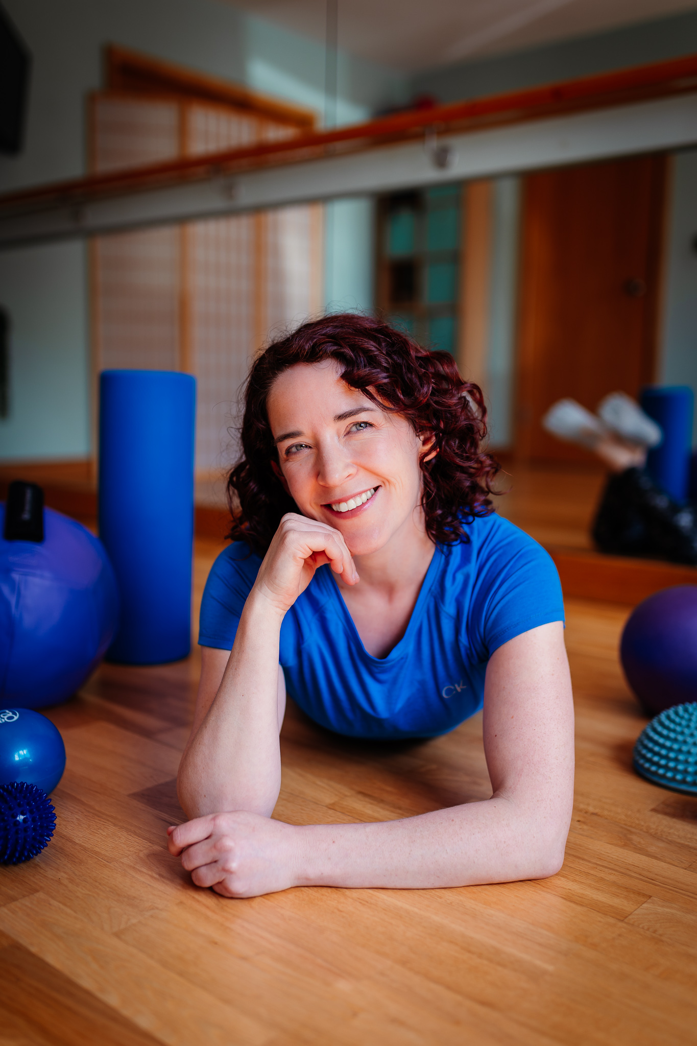 Emmeline Kemp surrounded by Pilates equipment on the floor of her studio Green Room Health in Danbury, Essex.