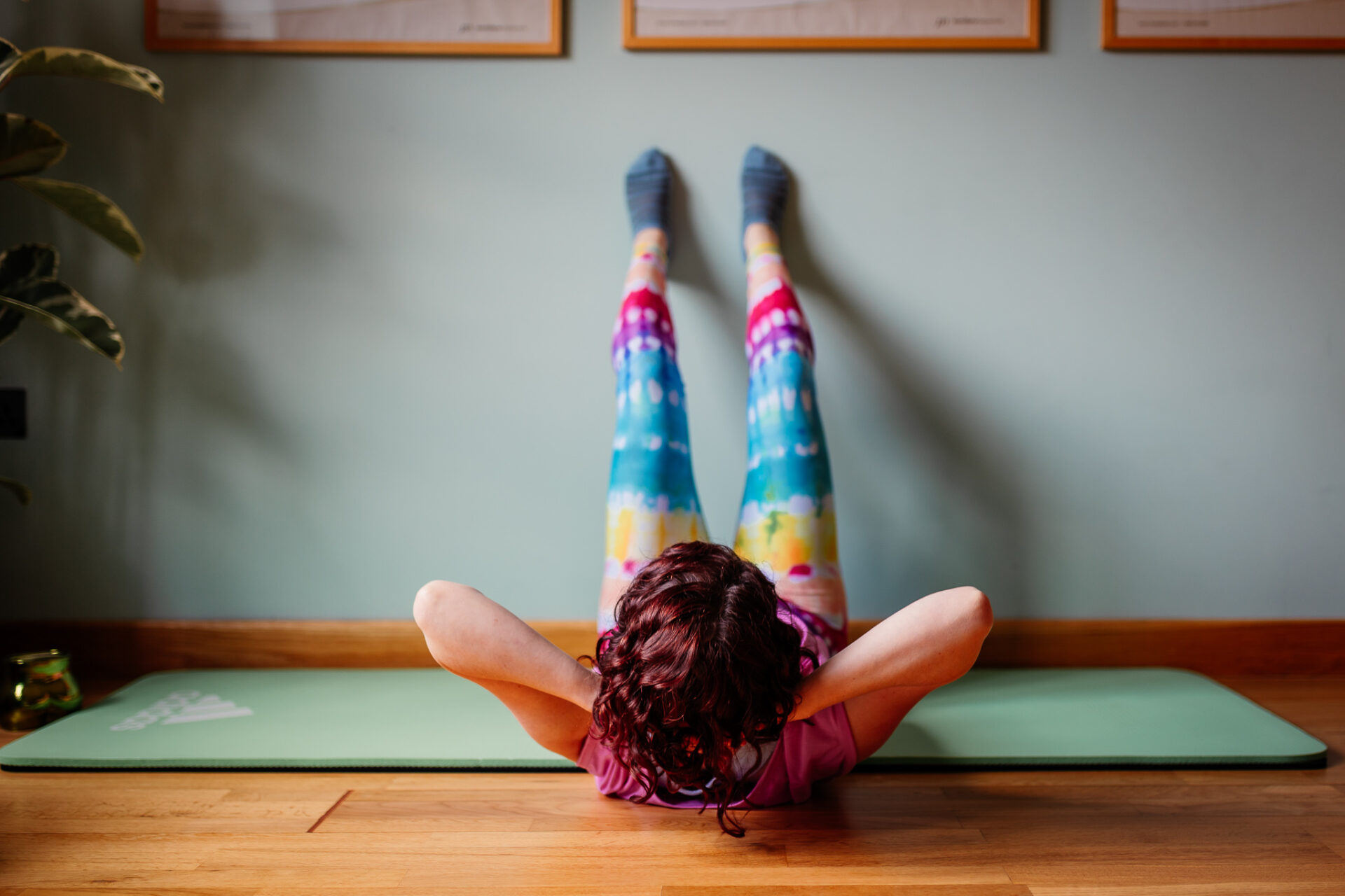Ab curls with feet on the wall helps make Pilates easier with Emmeline at Green Room Health