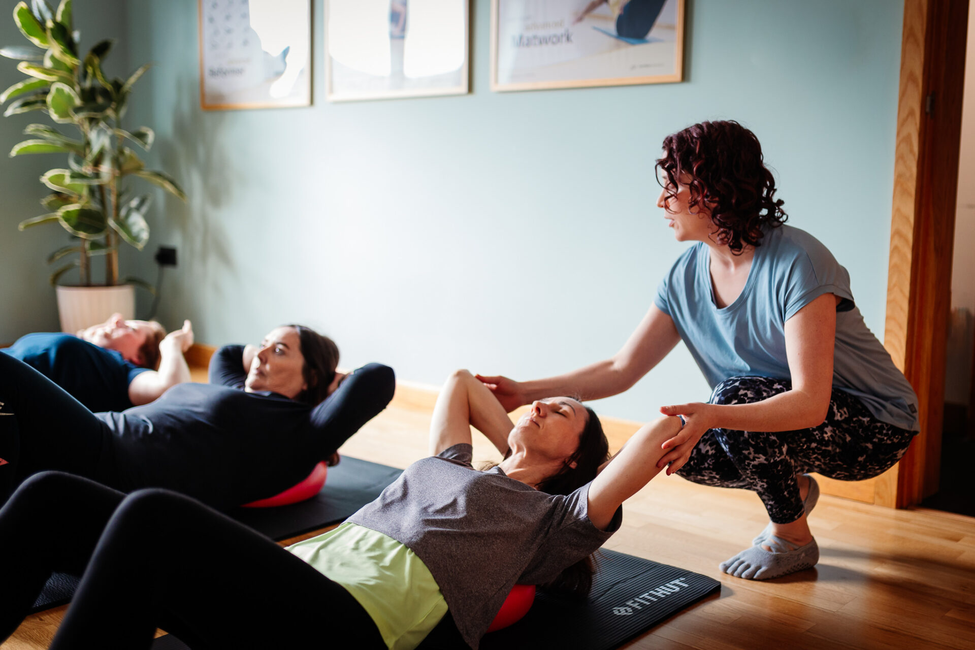 Emmeline teaches STOTT Pilates from her Studio in Danbury Essex. Participants are smiling and focussed.